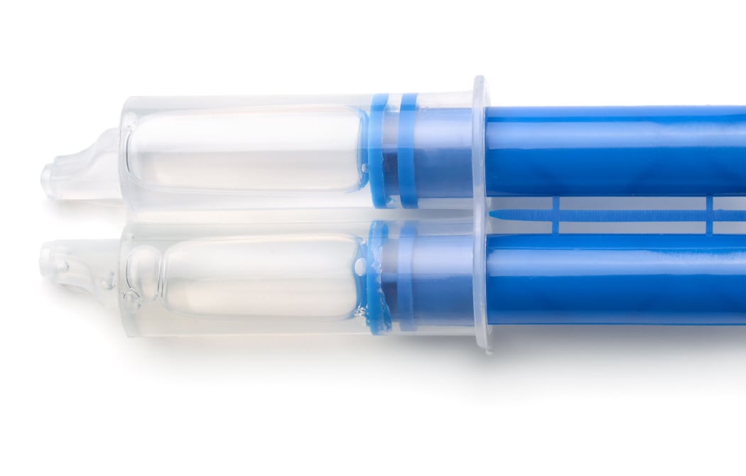 Top view of epoxy resin syringe isolated on white